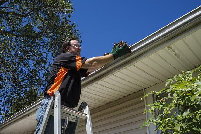 repairing damaged gutter with seamless aluminum material in Encino, CA